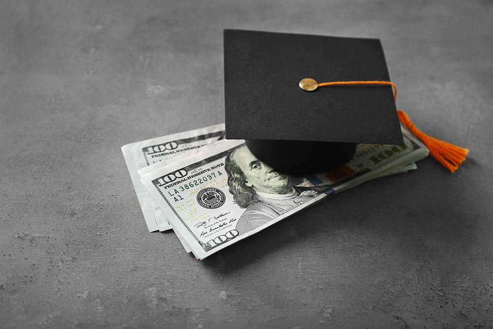 graduation cap and money pile